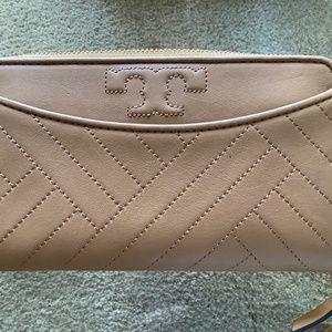 Tory Burch zippered camel leather wallet.